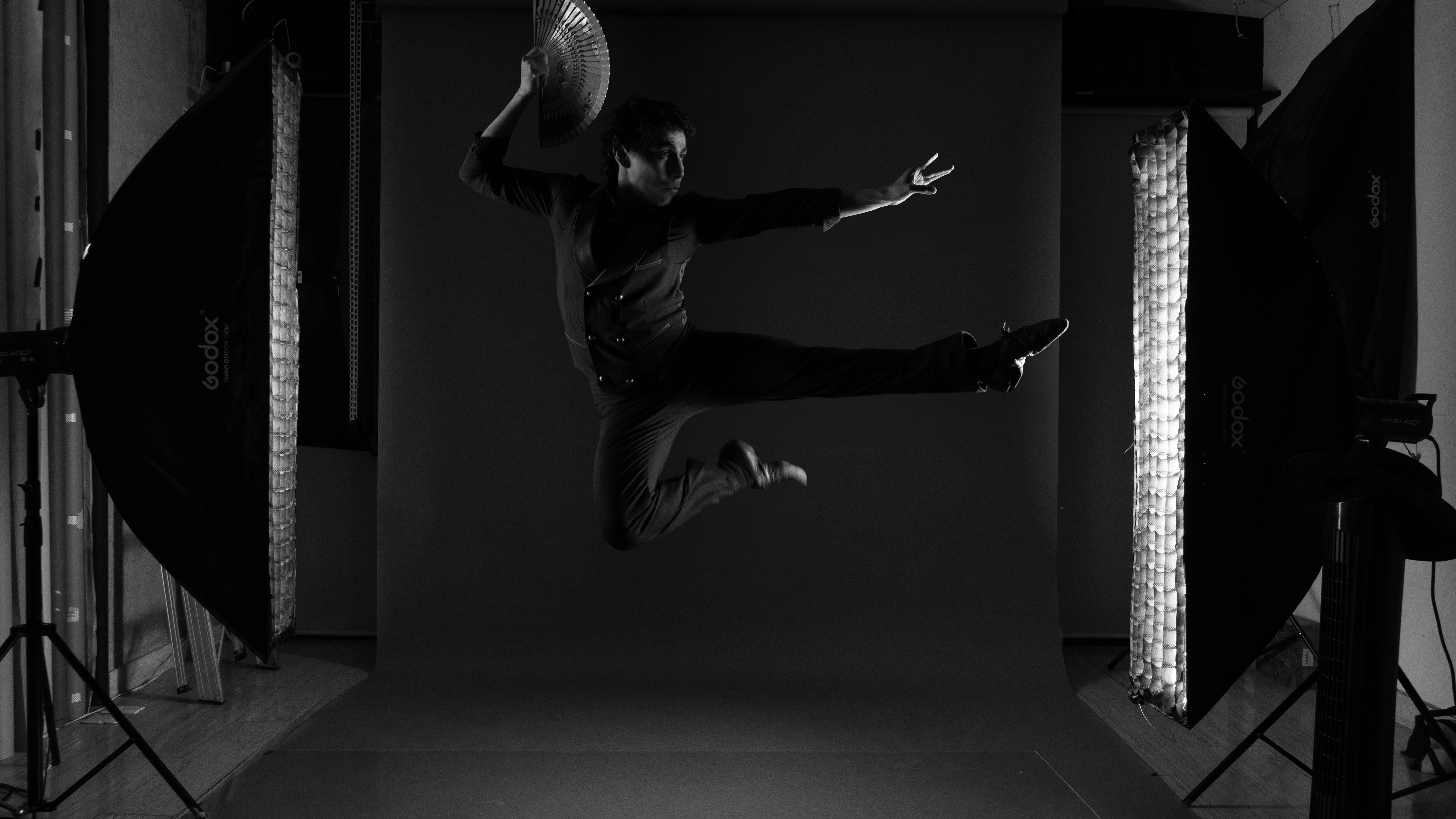 Motion capture performer in professional studio with tracking markers